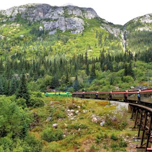 Train Turning through Coastal Mountains in Skagway, Alaska - Encircle Photos