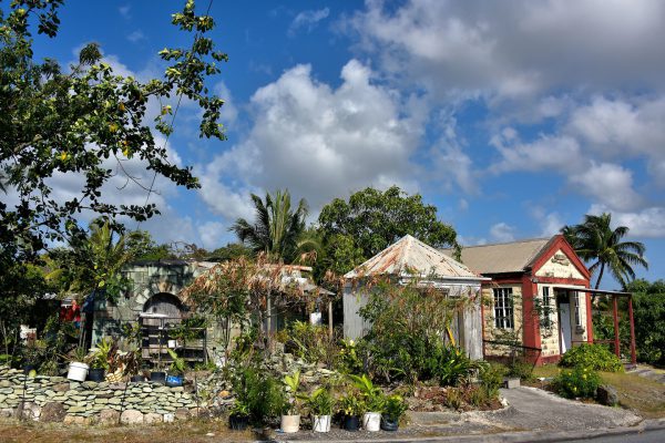 Green Stone Wall and Building in Liberta, Antigua - Encircle Photos