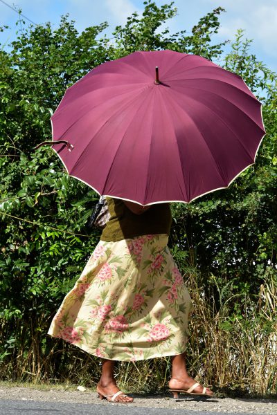 Woman Beneath Parasol to Shield Hot Sun in Liberta, Antigua - Encircle Photos