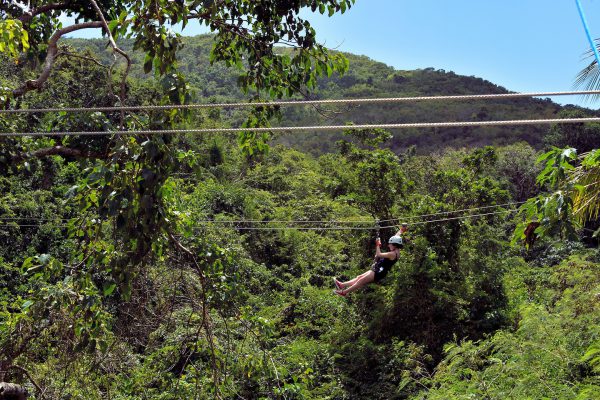 Woman Zip Lining in Rainforest in Wallings, Antigua - Encircle Photos
