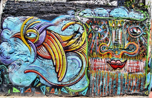 Stylized Bird and Abstract Face Mural near Avenida Independencia in Buenos Aires, Argentina - Encircle Photos