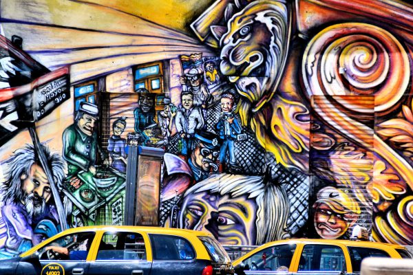 Taxis in Front of Faces and Lion Mural in Buenos Aires, Argentina - Encircle Photos