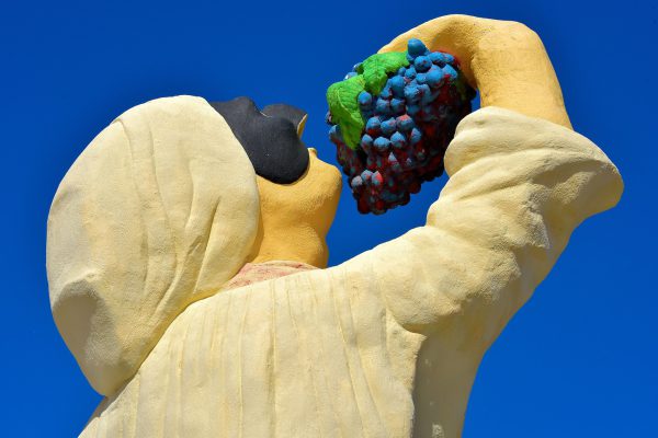 Chief Eating Grapes Statue in Palm Beach District, Aruba - Encircle Photos