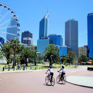 Cycling Past the Wheel of Perth at Barrack Square in Perth, Australia - Encircle Photos