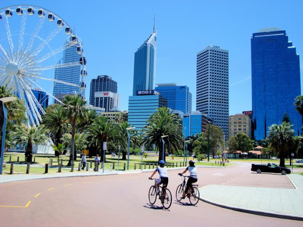 Cycling Past the Wheel of Perth at Barrack Square in Perth, Australia - Encircle Photos