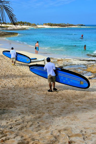 Crew Carrying Paddleboards at Great Stirrup Cay, Bahamas - Encircle Photos
