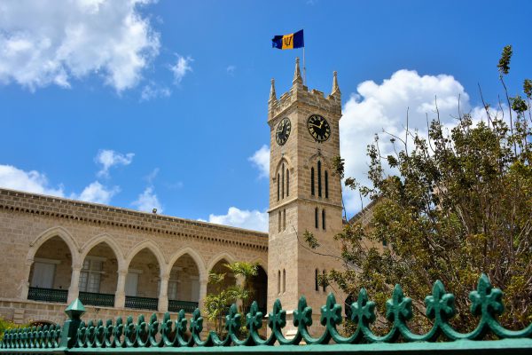 Flag above Clock Tower at Parliament Buildings in Bridgetown, Barbados - Encircle Photos