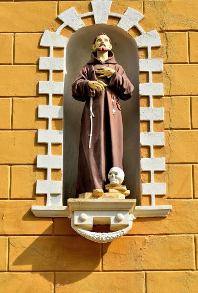 Monk Statue with Skull in Niche in Kralendijk, Bonaire - Encircle Photos