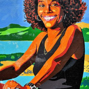 Young Woman Riding Bike Mural in Kralendijk, Bonaire - Encircle Photos