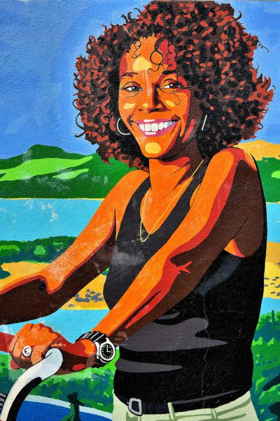 Young Woman Riding Bike Mural in Kralendijk, Bonaire - Encircle Photos