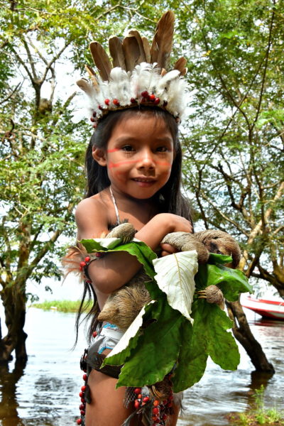 Young Girl Hugging Sloth in Boca da Valeria, Brazil - Encircle Photos