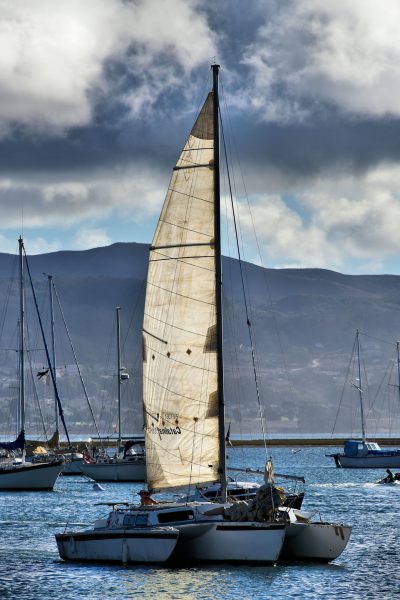 Sailboat Returning to Harbor at Dusk in Morro Bay, California - Encircle Photos