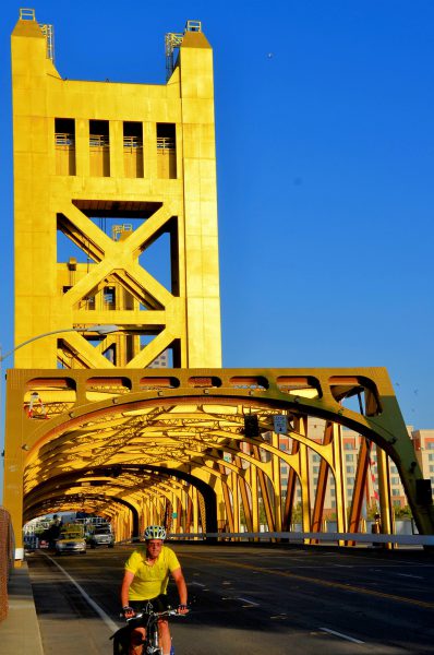 Gold Colored Tower Bridge and Bicyclist in Sacramento, California - Encircle Photos