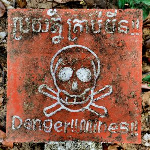 Danger Land Mines Sign with Skull and Crossbones at Koh Ker Temples, Cambodia - Encircle Photos