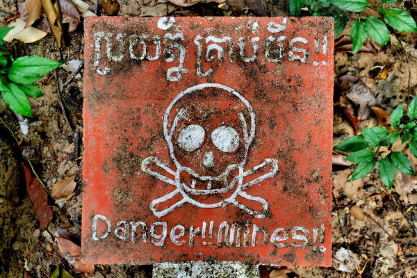 Danger Land Mines Sign with Skull and Crossbones at Koh Ker Temples, Cambodia - Encircle Photos