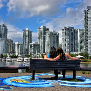 Romantic Couple on Bench Viewing Downtown Vancouver, Canada - Encircle Photos
