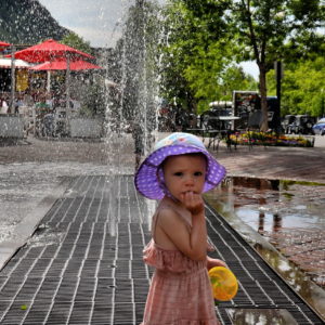 Little Girl With Bonnet Next to Mill Street Fountain in Aspen, Colorado - Encircle Photos
