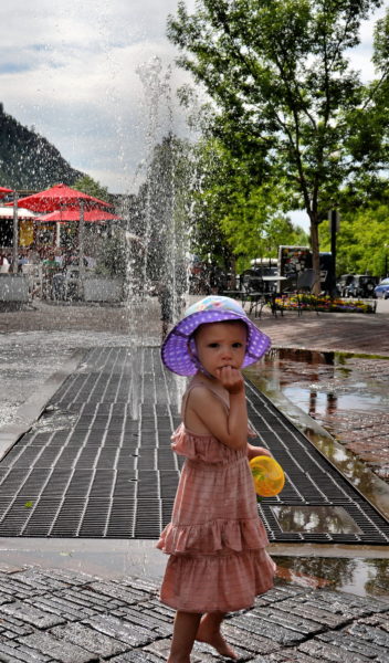Little Girl With Bonnet Next to Mill Street Fountain in Aspen, Colorado - Encircle Photos