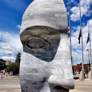 East 2 West Source Point Half Face Statue by Larry Kirkland in Denver, Colorado - Encircle Photos