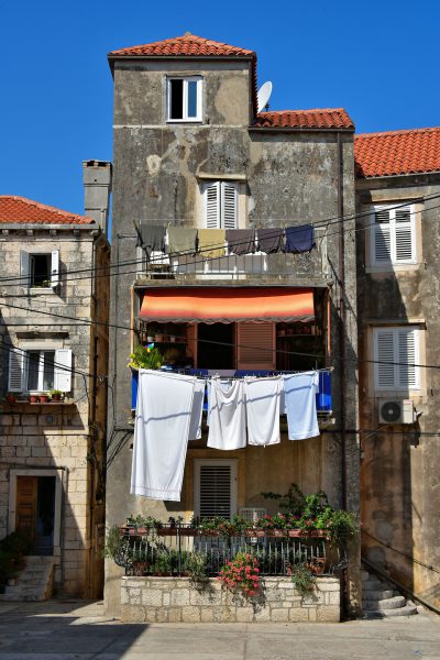 Laundry Hanging From Narrow House in Korčula, Croatia - Encircle Photos