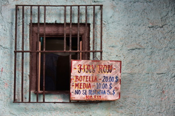 Selling Rum Behind Caged Window in Havana, Cuba - Encircle Photos