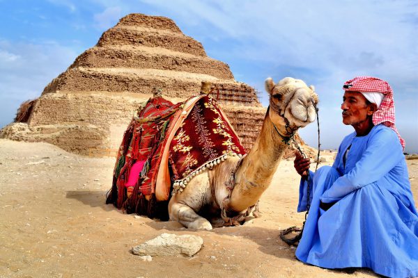Camel and Egyptian Man at Step Pyramid in Cairo, Egypt - Encircle Photos