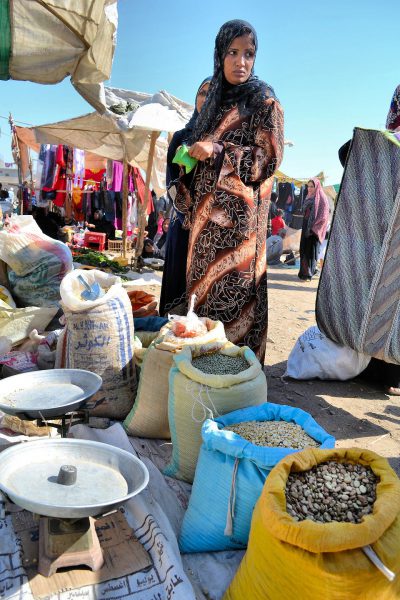Woman Shop for Grain at Market Wearing Abaya and Head Scarf in Luxor, Egypt - Encircle Photos
