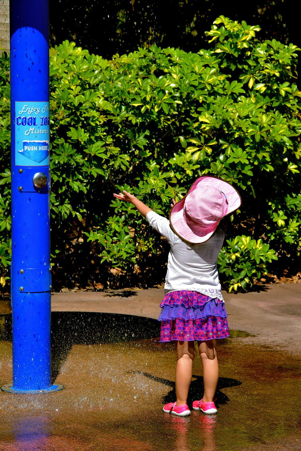 Young Girl Under Mister at Zoo Miami in Miami, Florida - Encircle Photos