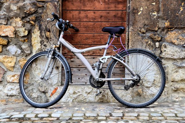 Bicycle Leaning against Wooden Door in Annecy, France - Encircle Photos