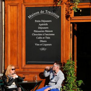 Man and Woman Drinking at Outside Restaurant Table in Paris, France - Encircle Photos