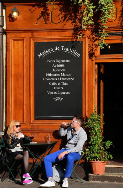 Man and Woman Drinking at Outside Restaurant Table in Paris, France - Encircle Photos