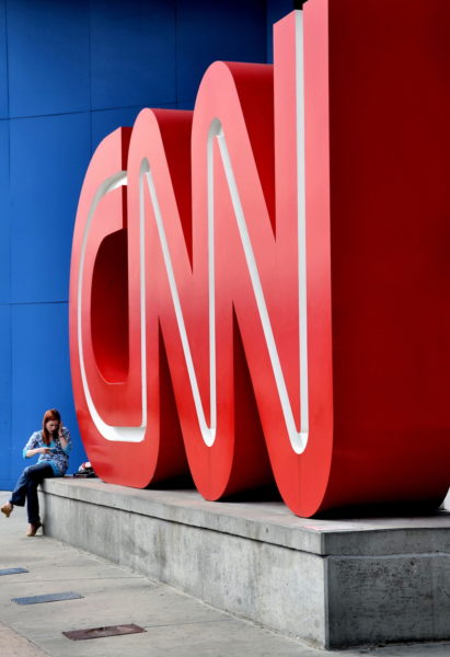 Girl on Cell Phone Next to the CNN Center’s Sign in Atlanta, Georgia - Encircle Photos