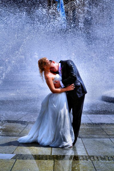Bride and Groom Embracing in Water Fountain in Munich, Germany - Encircle Photos