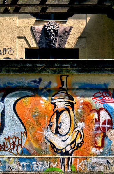 Graffiti and Cartoon Duck Mural under Gargoyle in Munich, Germany - Encircle Photos