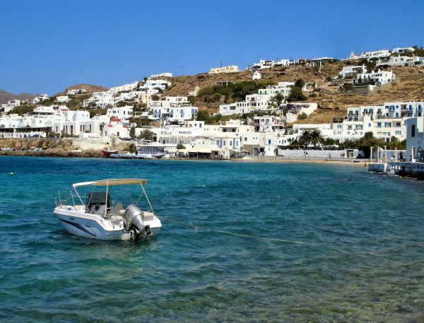 Boat Floating along Waterfront in Mykonos, Greece - Encircle Photos