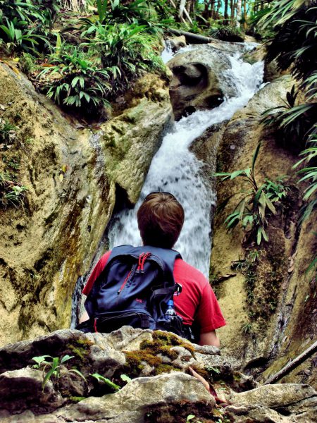 Boy Watching Waterfalls at La Paz Waterfall Gardens in San José, Guatemala - Encircle Photos
