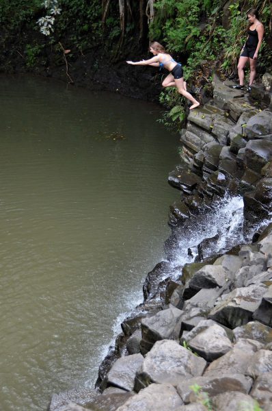 Woman Jumping Off Twin Falls in Ho’olawa Valley on Maui, Hawaii - Encircle Photos
