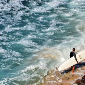 Male Surfer Carrying Board Along Beach near Kapalua on Maui, Hawaii - Encircle Photos