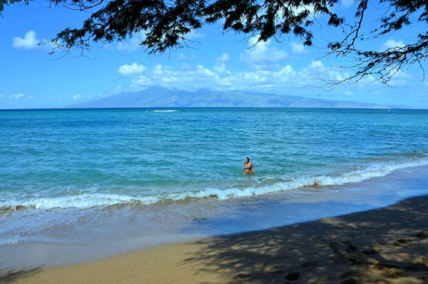 Woman Wading at D.T. Fleming Beach in Kapalua on Maui, Hawaii - Encircle Photos