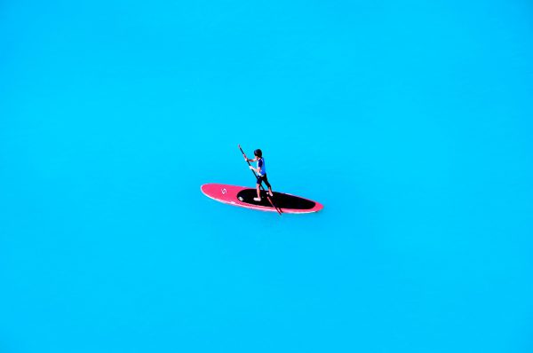 Boy Paddle Boarding on Open Blue Sea in Honolulu, O’ahu, Hawaii - Encircle Photos