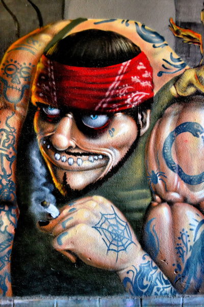 Pirate Face Red Bandana Tattoos Covering Steroid Arms Mural in Eger, Hungary - Encircle Photos