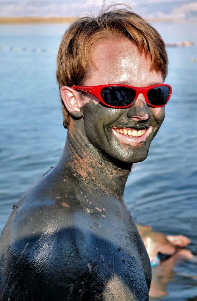 Young Man Covered in Dead Sea Mud at Dead Sea, Israel - Encircle Photos