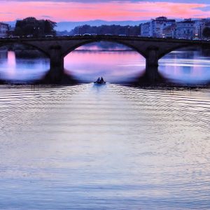 Ponte Santa Trinita Bridge and Boat on Arno River at Sunset in Florence, Italy - Encircle Photos