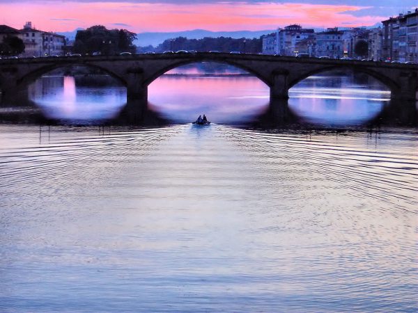 Ponte Santa Trinita Bridge and Boat on Arno River at Sunset in Florence, Italy - Encircle Photos