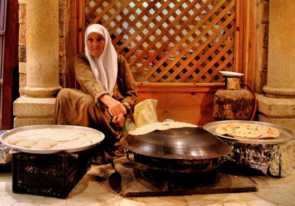 Old Woman Toasting Shrak or Bedouin Bread on Saj Hot Griddle in Jerash, Jordan - Encircle Photos