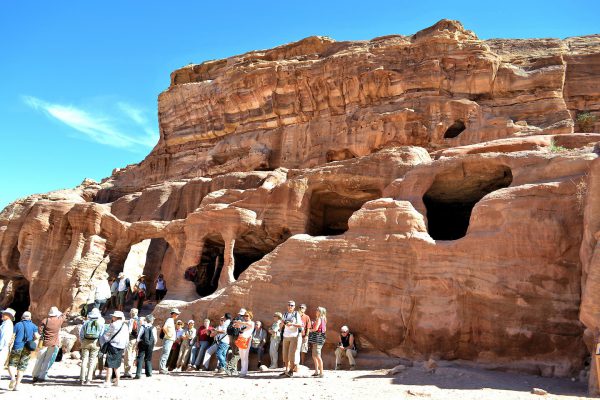 Tourists Standing By Tomb in Petra, Jordan - Encircle Photos