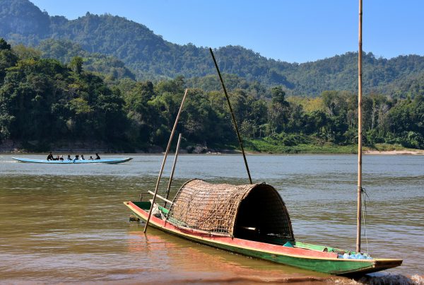 Thatched Canoe on Mekong River Shore in Ban Pak Ou, Laos - Encircle Photos