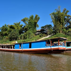 Slow Boat Moored along Shore in Luang Prabang, Laos - Encircle Photos