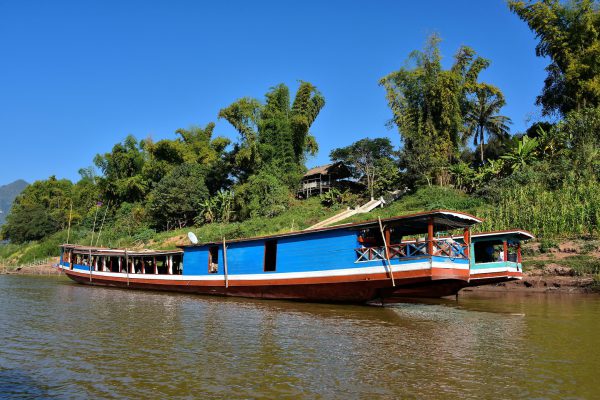 Slow Boat Moored along Shore in Luang Prabang, Laos - Encircle Photos