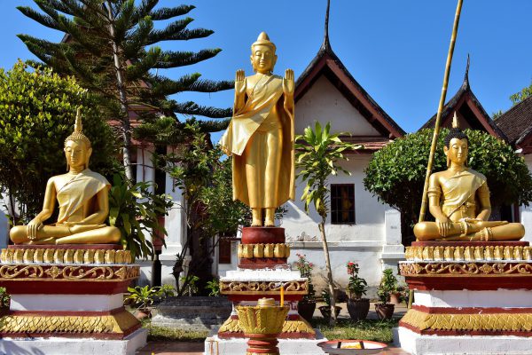 Three Buddha Statues in Courtyard at Wat Mai in Luang Prabang, Laos - Encircle Photos